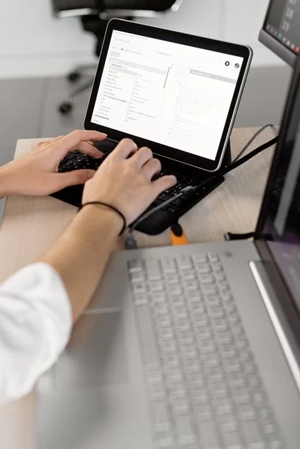 A person using a laptop to browse stock photo websites. Freelancing work in a cozy setting.